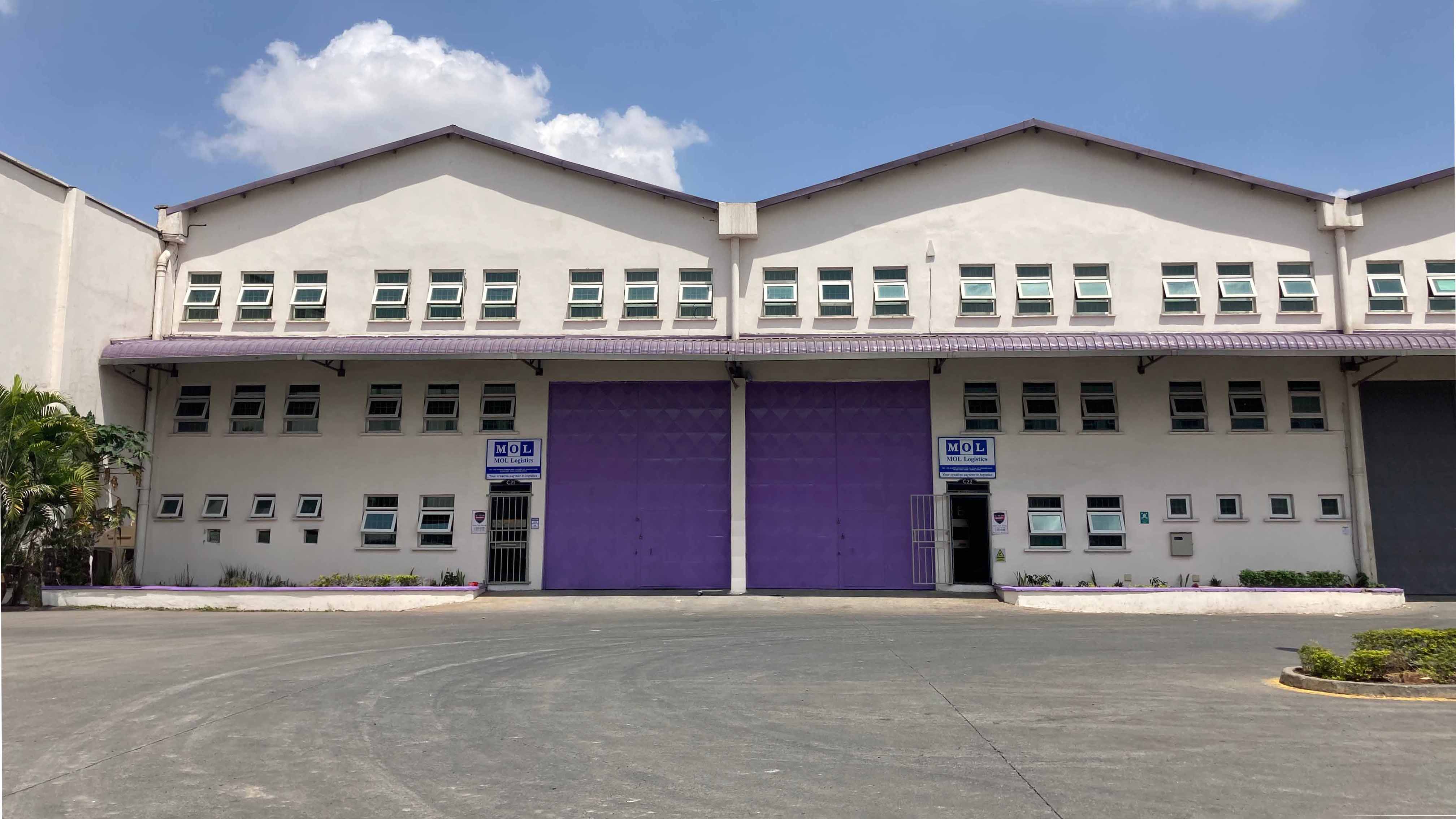 The MOL Logistics Nairobi warehouse with soft lavender-colored doors inspired by Kenya’s jacaranda flowers, symbolizing harmony between nature and industry.