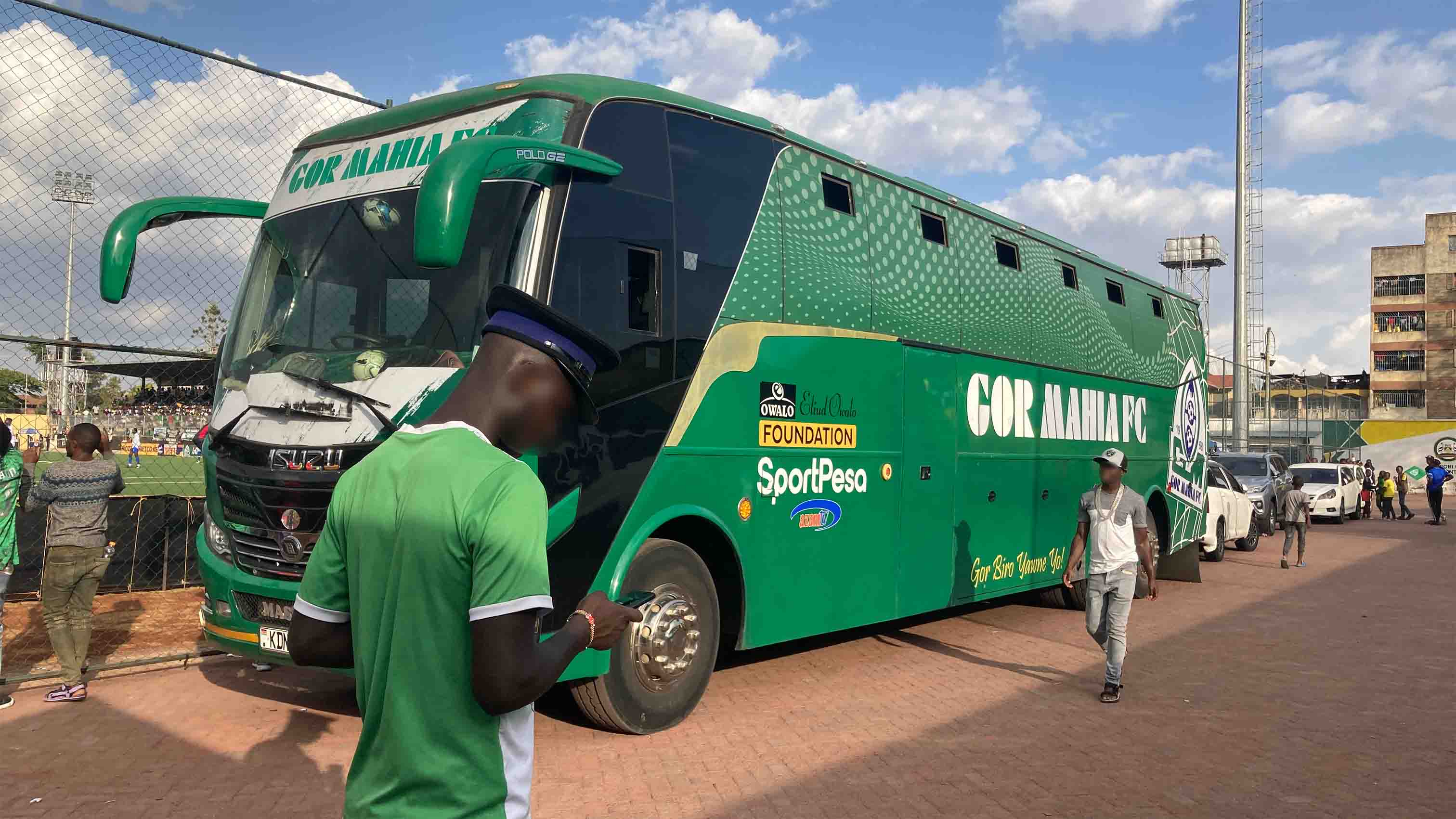 Gor Mahia team bus parked near the stadium with fans around.