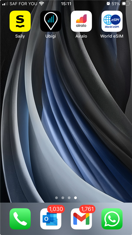 Phone screen with Saily, Ubigi, Airalo, and World eSIM apps.