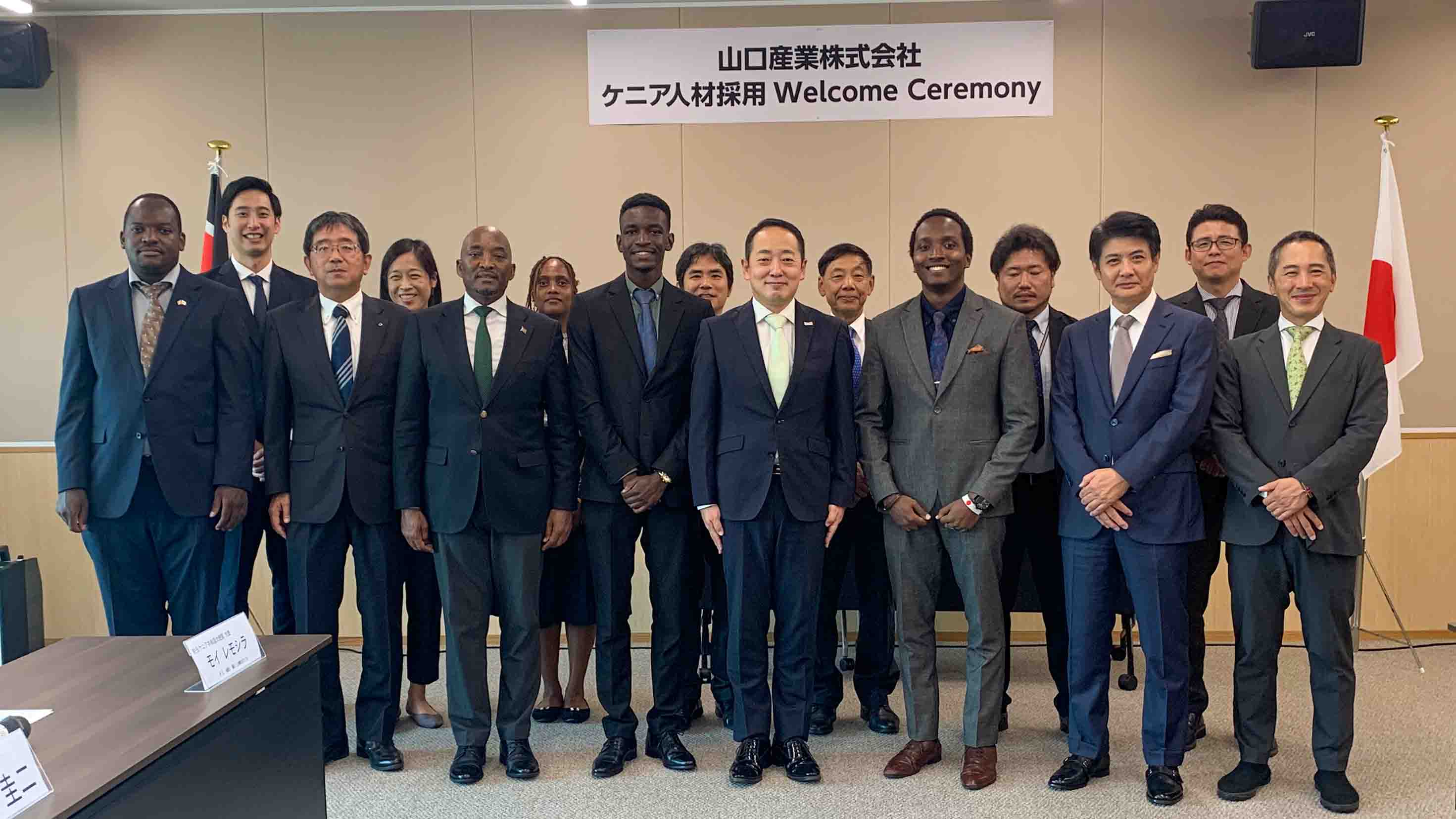 Group photo at Yamaguchi Sangyo’s welcome ceremony for Kenyan recruits, with company staff, MOL representatives, and the Kenyan Ambassador.