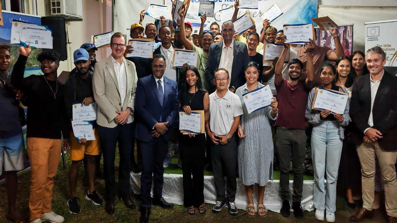 Group photo of young Mauritians holding skipper license certificates at the KRN award ceremony, joined by officials and supporters, celebrating their achievement in maritime training.