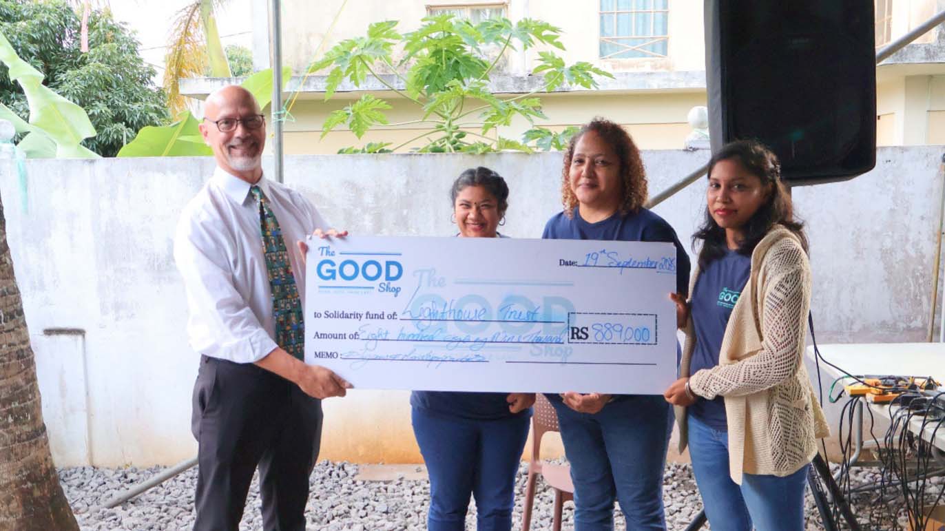 Representatives from The Good Shop present a symbolic cheque of MUR 889,000 to the Lighthouse Trust during their 7th anniversary event, supporting education scholarships for vulnerable children.