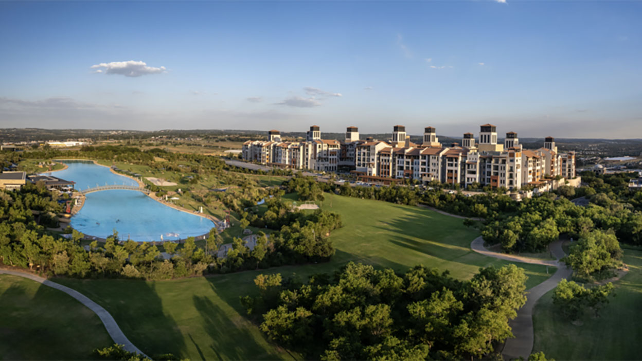 Johannesburg city skyline at sunset, with glowing orange skies and illuminated streets filled with cars — symbolizing South Africa’s vibrant yet contrasting urban life.