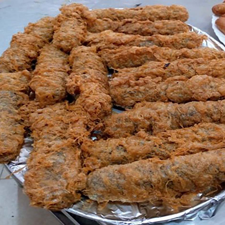 A tray of deep-fried Kenyan kebabs coated in a crispy golden batter.