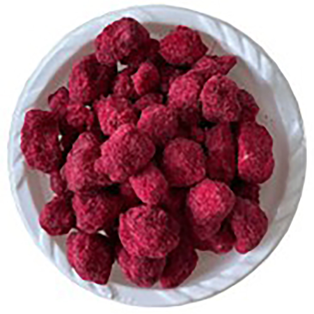 A bowl filled with mabuyu, bright red baobab-coated sweets.