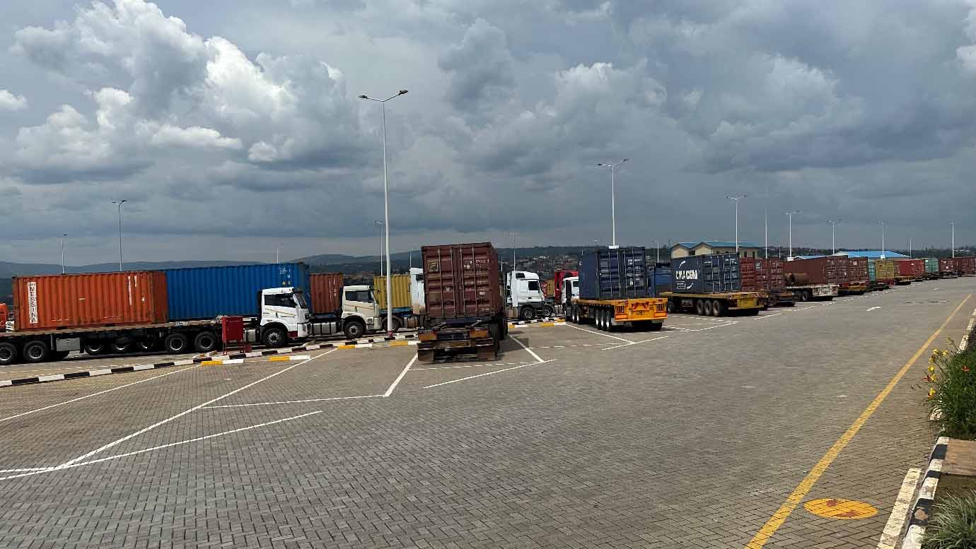 Container trucks lined up at an inland container depot in East Africa, representing cross-border cargo flows to landlocked countries.