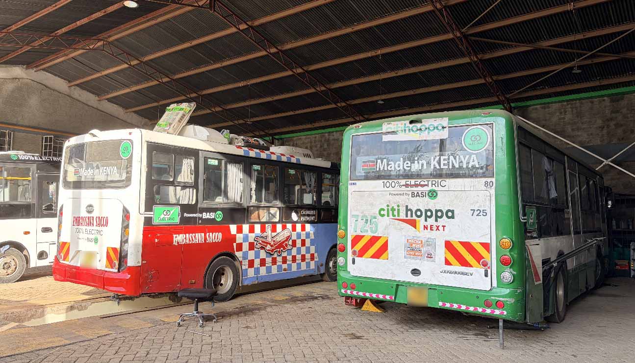 Electric buses displaying “Made in Kenya” branding inside BasiGo’s maintenance facility, highlighting local assembly efforts and the development of Kenya’s EV transport industry.