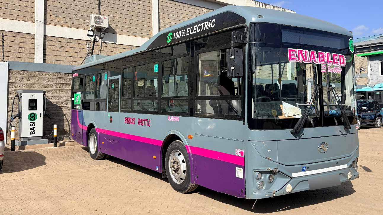 A BasiGo electric shuttle bus connected to a charging station at the company’s Nairobi facility, demonstrating Kenya’s growing electric mobility infrastructure.