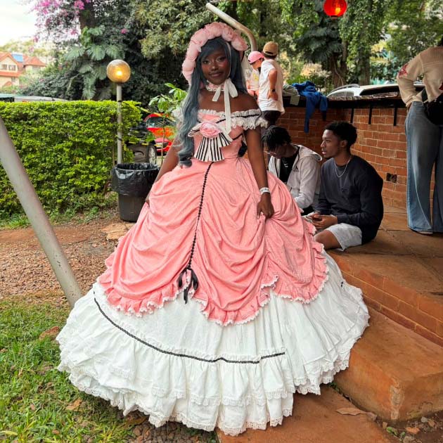  Cosplayer wearing an elaborate pink and white dress posing outdoors during a Japanese cultural festival in Kenya.