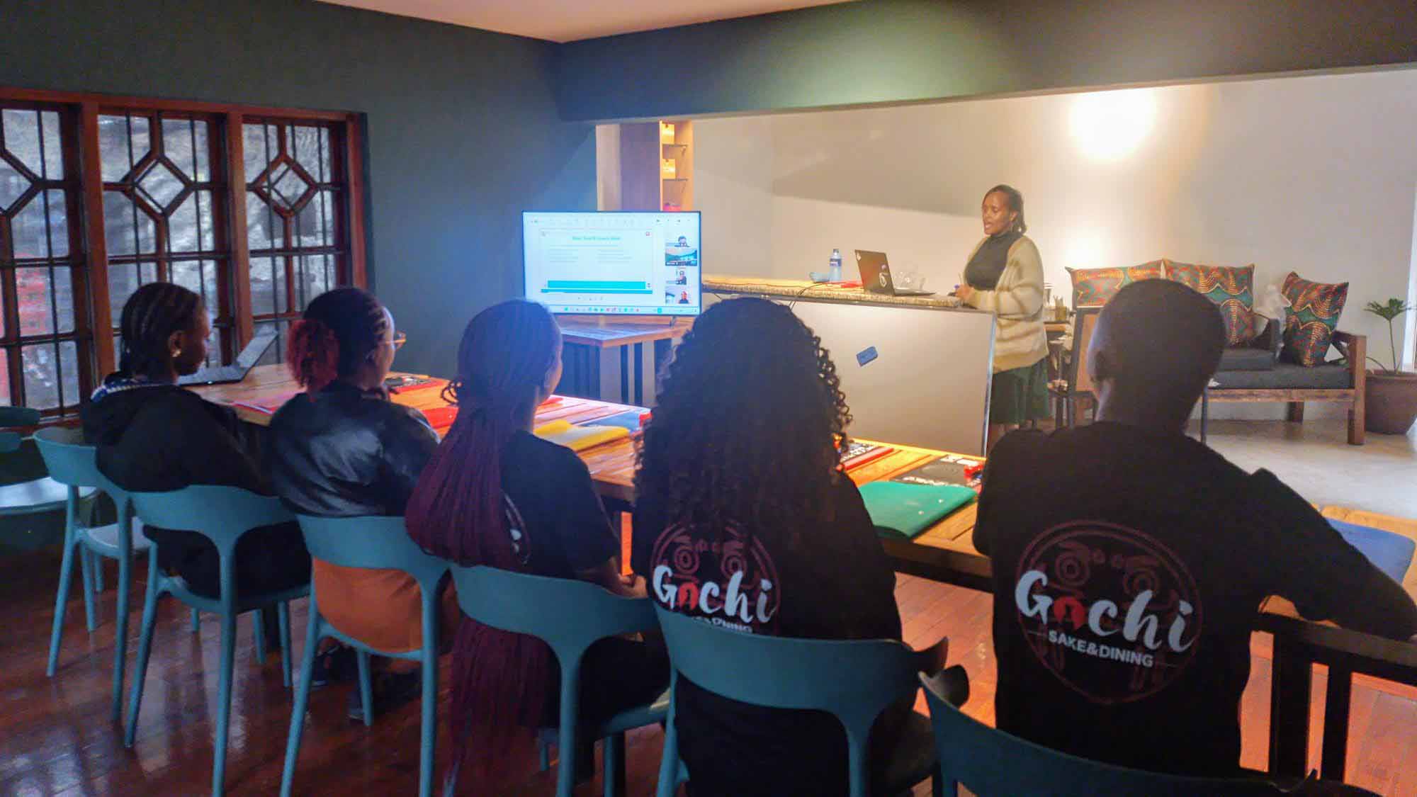 Students attending a Japanese language class at Gochi Japanese Restaurant in Nairobi, with the instructor teaching at the front of the room.