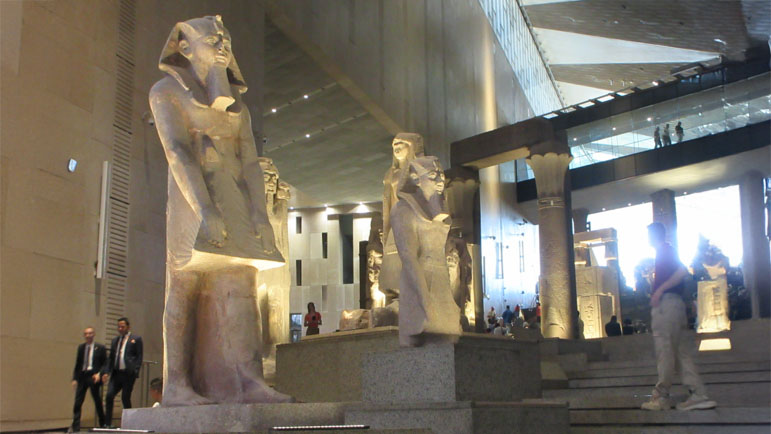Monumental ancient Egyptian statues displayed in the Grand Egyptian Museum’s spacious exhibition hall, showcasing the impressive craftsmanship and artistic achievements of ancient Egyptian civilization.