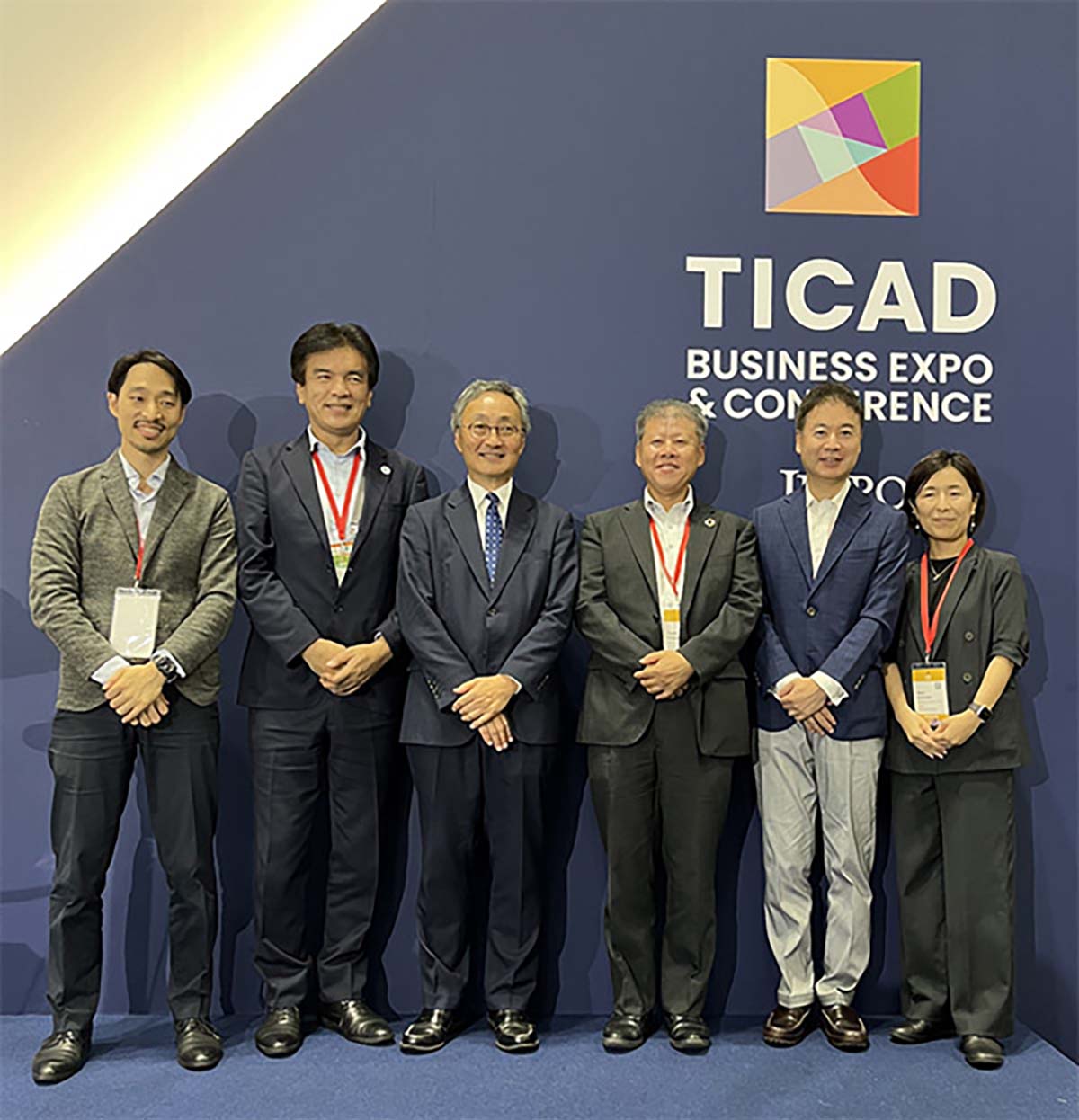 MOL executives and representatives pose for a group photo in front of the TICAD 9 Business Expo & Conference backdrop.
