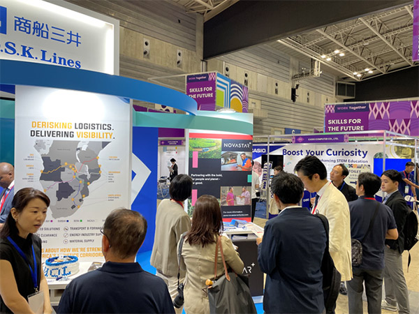 Attendees view a display panel at MOL’s booth highlighting logistics visibility and risk reduction across Africa.