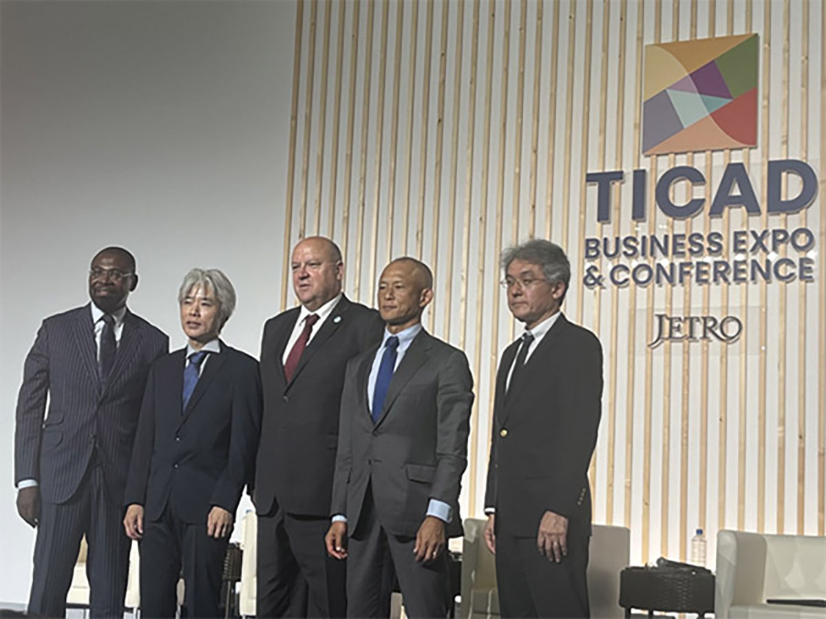 A group photo of international speakers and dignitaries at the TICAD 9 Business Expo & Conference stage.